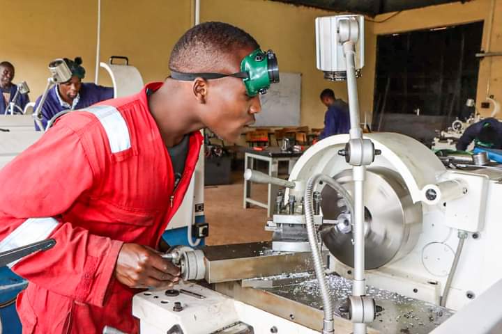 Mechanical trainee demonstrating a skill in the workshop
